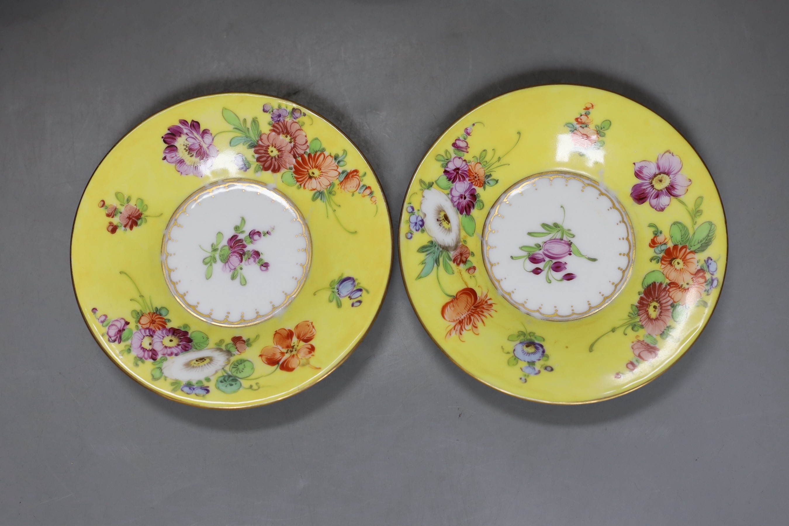 A set of four Dresden yellow ground cups and saucers